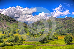 Langdale Valley Lake District Cumbria with mountains bright blue sky and whites clouds colourful hdr