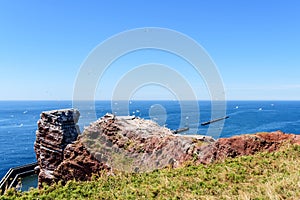 Lange Anna sea stack rock on Helgoland island against blue sea on clear day