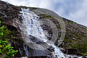 Langfossen Langfoss waterfall in summer, Etne, Norway