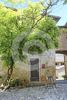 Langhirano, Italy: Streets of medieval small city borgo around the castle castello Torrechiara with old houses, signboards