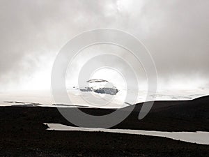 Langjokull glacier: white snow and black rock mountain. Contrasts of Icelandic Nature. West Iceland, Europe
