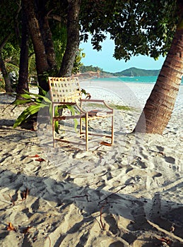 Langkawi Island. Chair & Book between Palm Trees