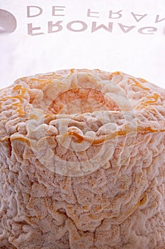 A Langres cheese with original wrapping paper