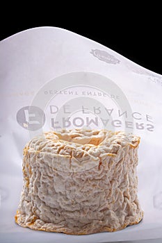 A Langres cheese with original wrapping paper