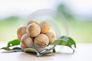 Langsat with green leave on wood table