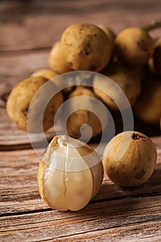 Langsat or Lanzones on wooden background