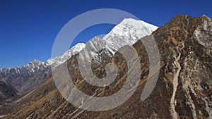 Langtang Lirung, high mountain of the Langtang Himal range. Kyangjin Ri, viewpoint abobe Kyangjin Gumba, Nepal. Spring day.