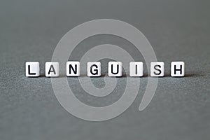 Languish - word concept on cubes