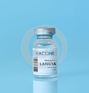 Langya henipavirus LayV vaccine vial on a blue background.The concept of medicine, healthcare and science. Langya 2022 virus. photo