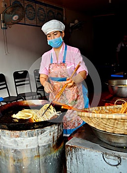 Langzhong, China: Woman Frying Noodles