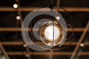 Lanp hanging from the ceiling of a restaurant.. photo