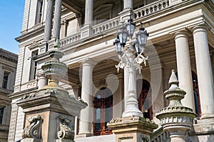 Lansing MI - May 6, 2023: Main entrance to the Michigan Capitol building with ornate masonry and lamppost