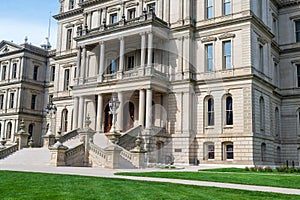 Lansing MI - May 6, 2023: Main entrance to the Michigan Capitol building with ornate masonry and lamppost