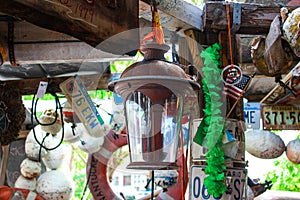 Lantern and American flag and bouys and license plates from various states hanging in a rustic building in Key West Florida