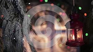 Lantern on a background of snow-covered window with Christmas lights