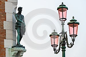 Lantern and bronze statue of a man in Venice