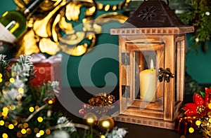 Lantern with candle and Christmas decorations on a old wooden table