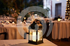 Lantern with candle terrace restaurant and flowers