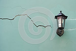 Lantern on the cracked wall.