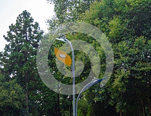 Lantern in the form of a tree leaf. Lighting in the park. Unusual street lighting design
