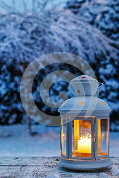 Lantern in garden, winter evening