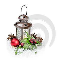 Lantern and holly berries on a snow