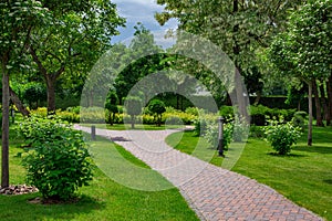 Lantern iron ground garden lighting of curved park path.