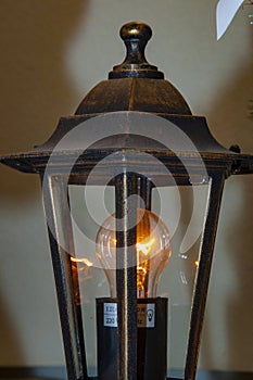 Lantern with light on. Streetlamp bulb. Streetlight lantern. Lantern for street