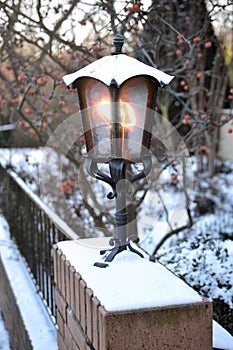 Lantern on neighborhood garden fence christmas card winter