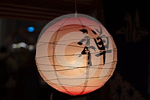 The lantern in the night illuminates the dark street