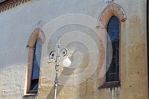 Lantern between the windows with arches photo
