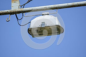 Lantern on the pole. Streetlight against a blue sky with clouds