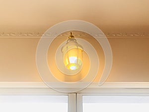 Lantern sconce. Wall lamp above floor-to-ceiling glass door.