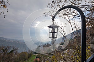 Lantern with sun rays and clouds in the background