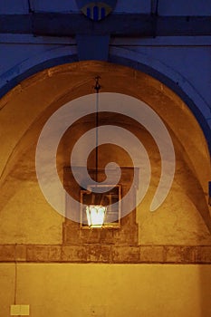 Lantern under an arch of the Palace of the Lodges, Arezzo, Tuscany - Italy