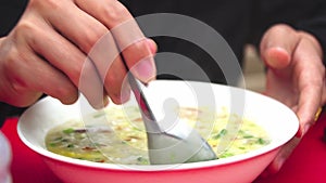 A Laotian eating rice soup the traditional lao food