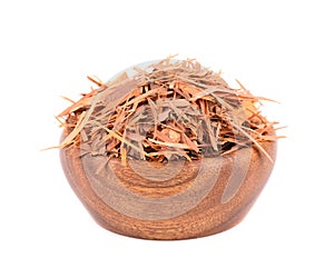 Lapacho herbal tea in wooden bowl, isolated on white background. Natural Taheeboo dry tea. Pau d'arco herb. Tabebuia photo