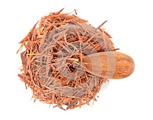 Lapacho herbal tea in wooden spoon, isolated on white background. Natural Taheeboo dry tea. Pau d'arco herb. Tabebuia