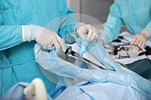 Laparoscopic instruments in the hands of a surgeon. Laparoscopic surgery. Surgery through small holes in the abdominal photo