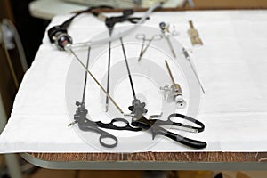 Laparoscopic instruments on the operating table in the surgical room.