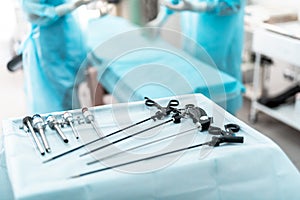 Laparoscopic surgical instruments on sterile desk in operating room