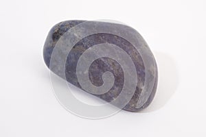 A blue Lapis Lazuli gemstone shot against a white studio background