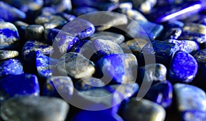 Lapislazuli Selected, beautiful color, laying on the ground, with reflection	valuable, expensive and rare. For making jewelry photo