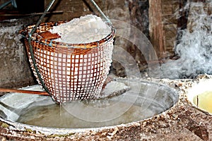 Lapping crystallized salt from boiled saltwater to dried .