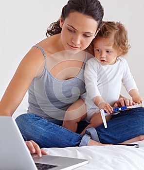 Laptop, baby and mother in bed for remote work, learning or online education in home. Freelancer parent, computer and