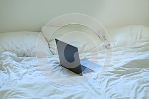 Laptop on bed. Work from home concept.