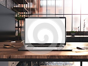 Laptop with blank screen mockup template on table in industrial old factory loft interior