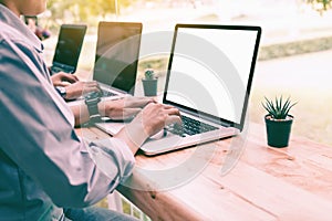 Laptop blank screen with people typing on keyboard looking somet