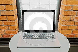 Laptop with blank screen on table