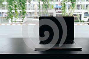 Laptop with blank screen on table, Conceptual workspace, Laptop computer with blank white screen on table, Green background